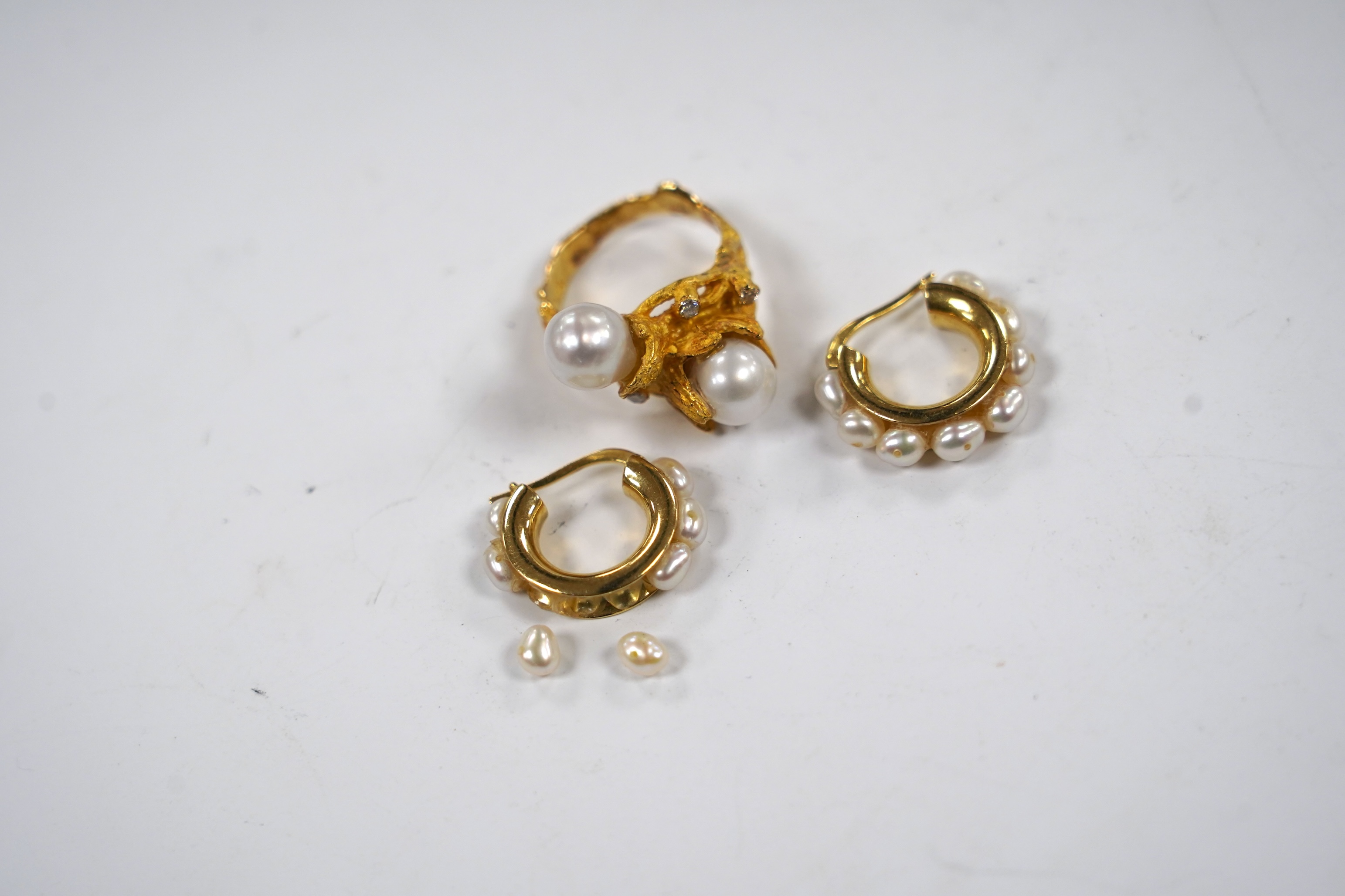 A recent 750 yellow metal two stone cultured pearl and three stone diamond chip set modernist ring, size M/N, gross 9.7 grams and a pair of baroque pearl set half hoop earrings (a.f.).
